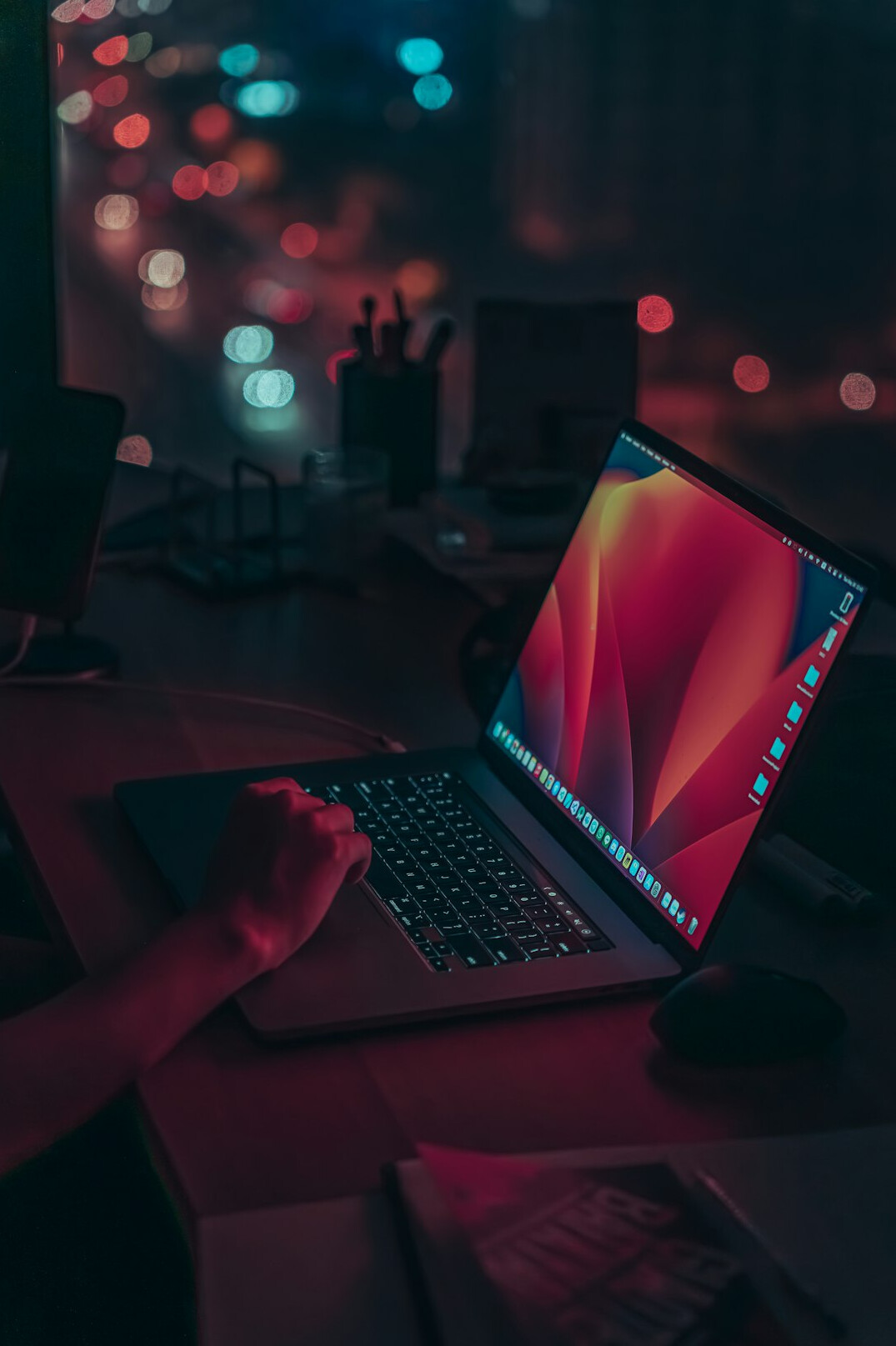 writer typing on laptop at night